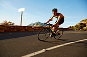 Male cyclist cycling on corner