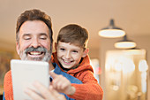 Father and son bonding, sharing tablet