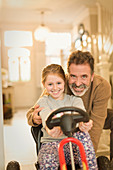 Portrait smiling father and daughter playing