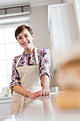Portrait smiling brunette woman in apron