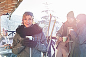 Portrait smiling female skier drinking coffee