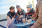 Skier friends drinking and eating