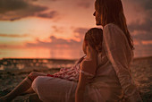 Serene mother and daughter on beach