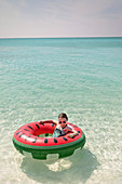 Portrait girl floating in inflatable ring
