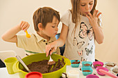 Bbrother and sister making chocolate cupcakes