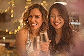 Portrait women friends toasting champagne flutes