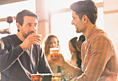 Men friends sampling beer at microbrewery bar