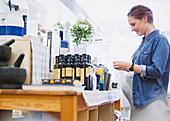 Pregnant woman shopping, browsing olive oil