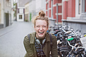 Laughing young woman on city street