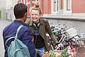 Young man and woman with bicycle laughing