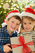 Brother and sister holding Christmas gift