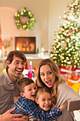 Family taking selfie in Christmas living room
