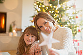 Mother and daughter holding Christmas star