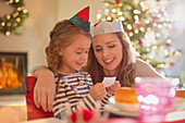 Mother and daughter wearing paper crowns