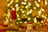 Red wine and candles on Christmas dinner table