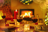 Red wine and candles on Christmas table