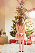 Girl in pink dress holding Christmas gift