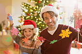 Smiling father and daughter in Santa hats