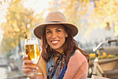 Young woman toasting beer glass