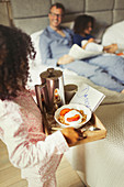 Girl serving breakfast to father on Father's Day