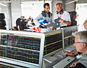 Formula one racing team reviewing diagnostics