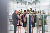 Business people greeting, handshaking in lobby