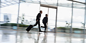 Businessmen running with suitcase