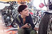 Female motorcycle mechanic repairing motorcycle