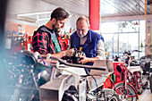 Male motorcycle mechanics repairing part