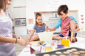 Mother and children baking cookies