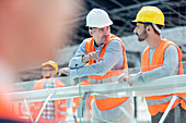Male foreman and construction worker talking