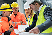 Engineers and construction workers discussing