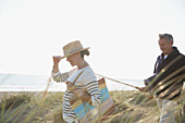 Mature couple with fishing rod walking