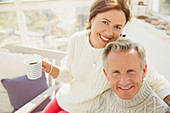 Portrait mature couple hugging and drinking coffee