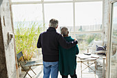 Affectionate senior couple enjoying beach view