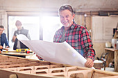 Portrait male carpenter reviewing plans