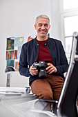 Portrait, male photographer with digital camera