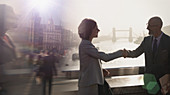 Silhouette business people handshaking, London, UK