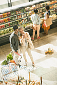 Young couple taking selfie in market