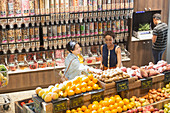 Young women, browsing produce in market