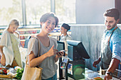 Portrait woman at grocery store checkout