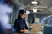 Businesswoman using VR simulator at laptop