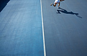 Shadow of tennis player running