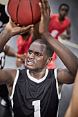 Focused basketball player shooting the ball