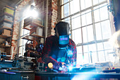 Welder welding with welding mask and torch