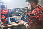 Male engineer assembling electronics