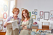 Portrait artists holding painted bench