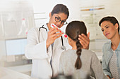 Female doctor using digital thermometer