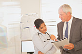 Doctor and administrator reviewing paperwork