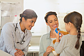 Paediatrician and girl using inhaler